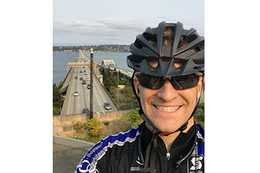 Man with bike helment taking a selfie