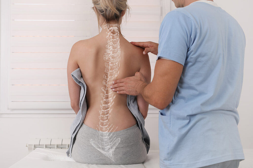A woman with an overlay of a spine with Scoliosis drawn on her back.